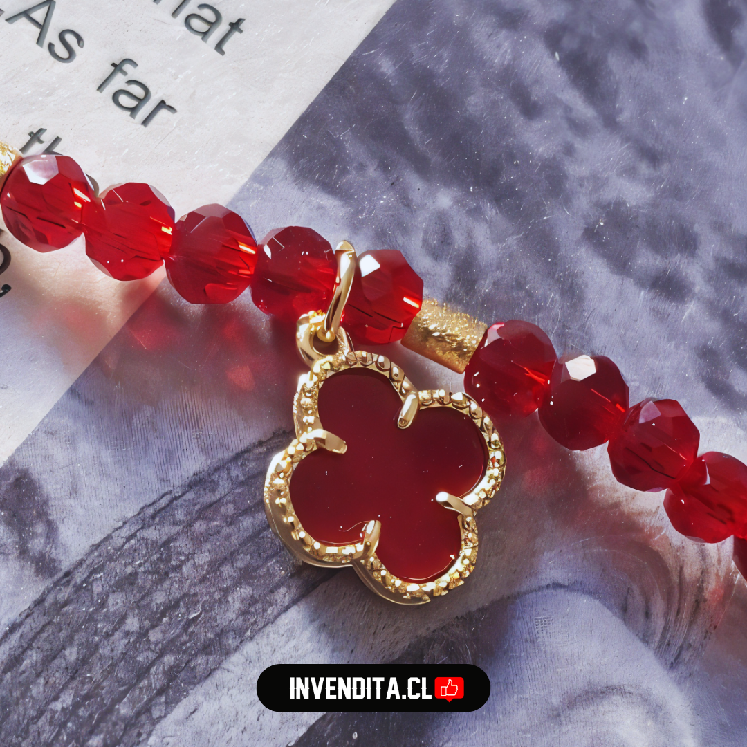 Pulsera enchapada en oro cristales rojos y dije de flor